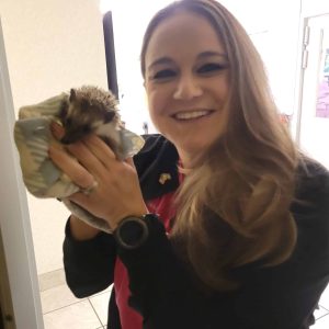 Staff member holding a small pet