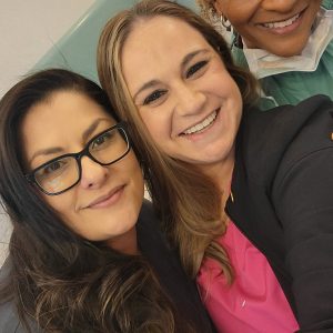 Team members smiling for a selfie