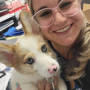 Smiling woman holding a puppy