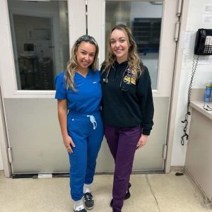 Two staff members posing together