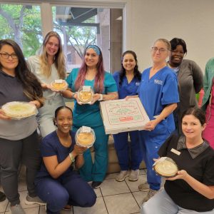 Group of staff with awards and food