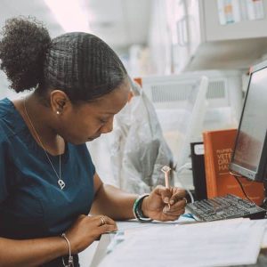 Staff writing notes at their desk